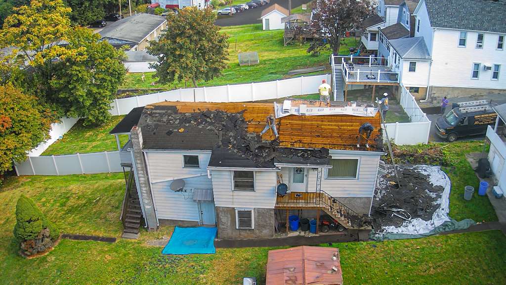 Aerial view of professional roof replacement in progress